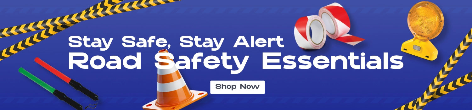 Road safety products including traffic cones, reflective tape, LED safety lights, and signal wands displayed on a blue background with the text 'Stay Safe, Stay Alert – Road Safety Essentials' and a 'Shop Now' button.